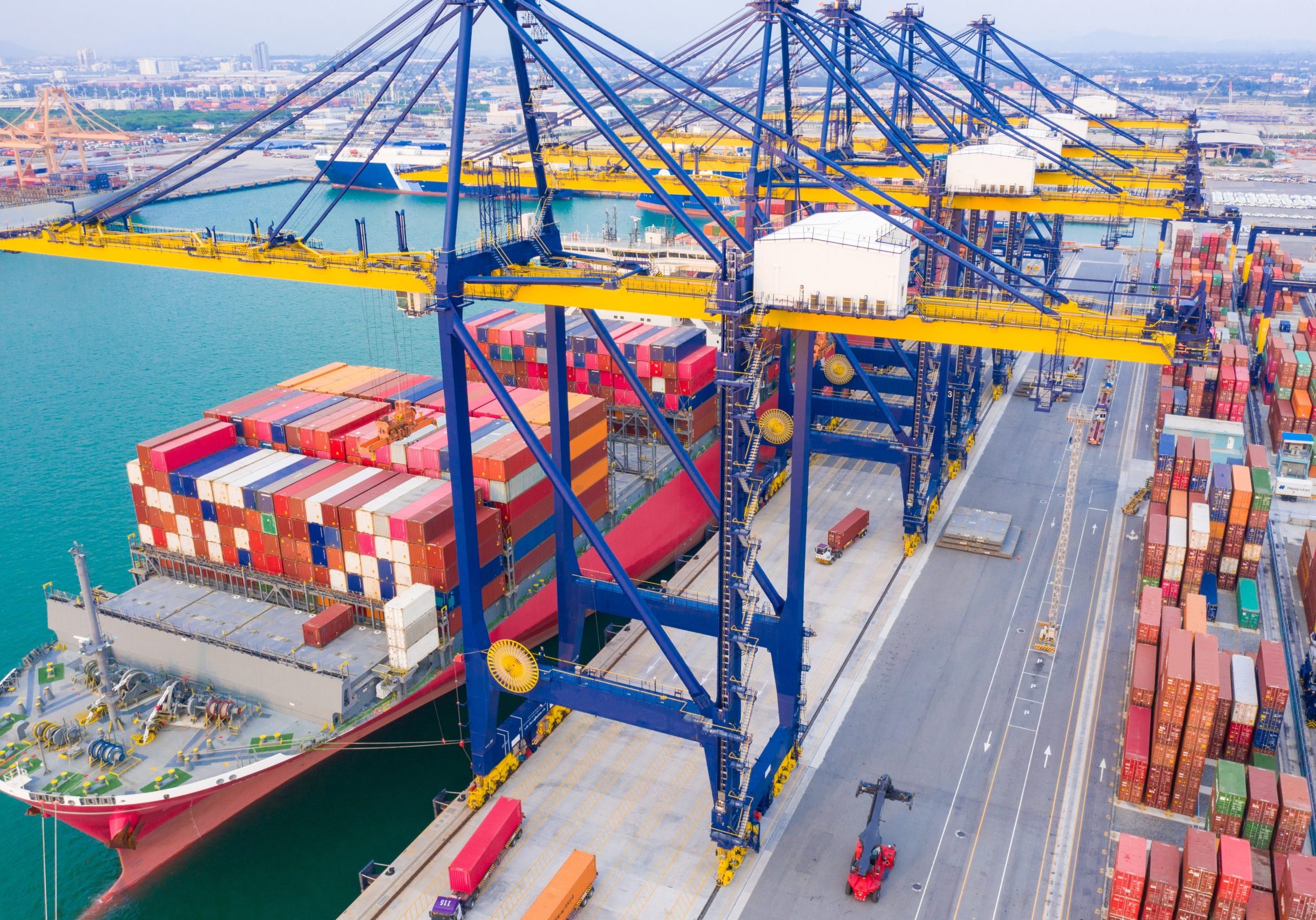 Container ships at industrial ports in the business of import, export, logistics and international maritime transport, loading of containers on cargo ships with cranes,
Transportation of goods by container trucks to customers.